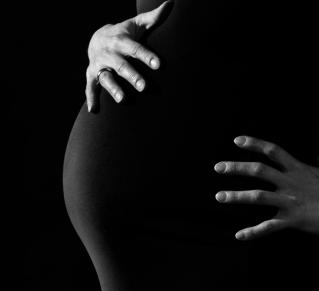 Femme enceinte qui met ses deux mains sur son ventre