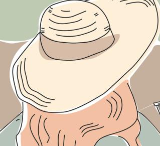 Une femme de dos avec un chapeau sur la tête, fait face à un chantier de fouilles archéologies